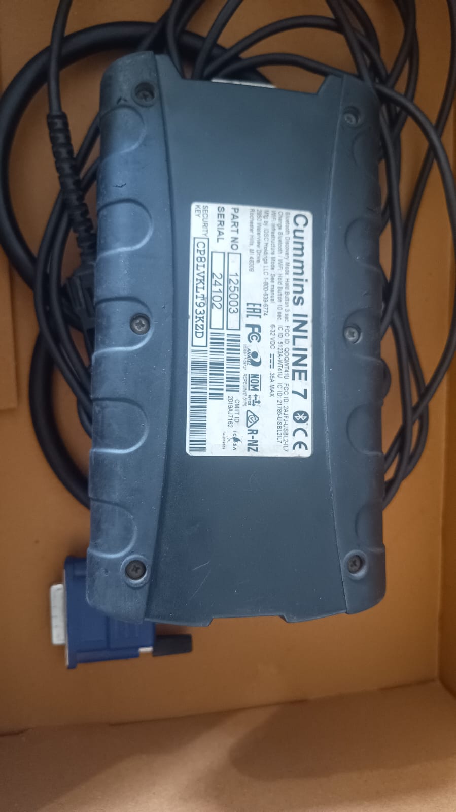 Blue electronic component with Cummins INLINE 7 label on a brown background