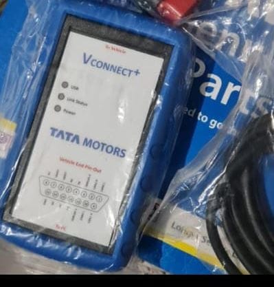 VConnect+ device with Tata Motors branding, surrounded by plastic packaging.