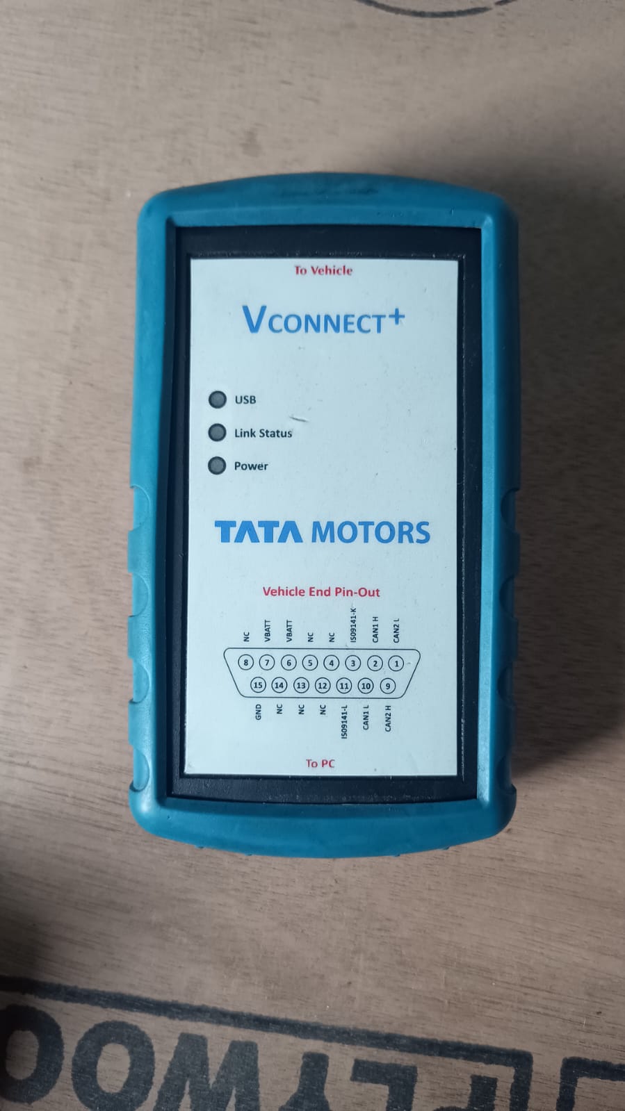 Tata Motors diagnostic tool on a wooden surface