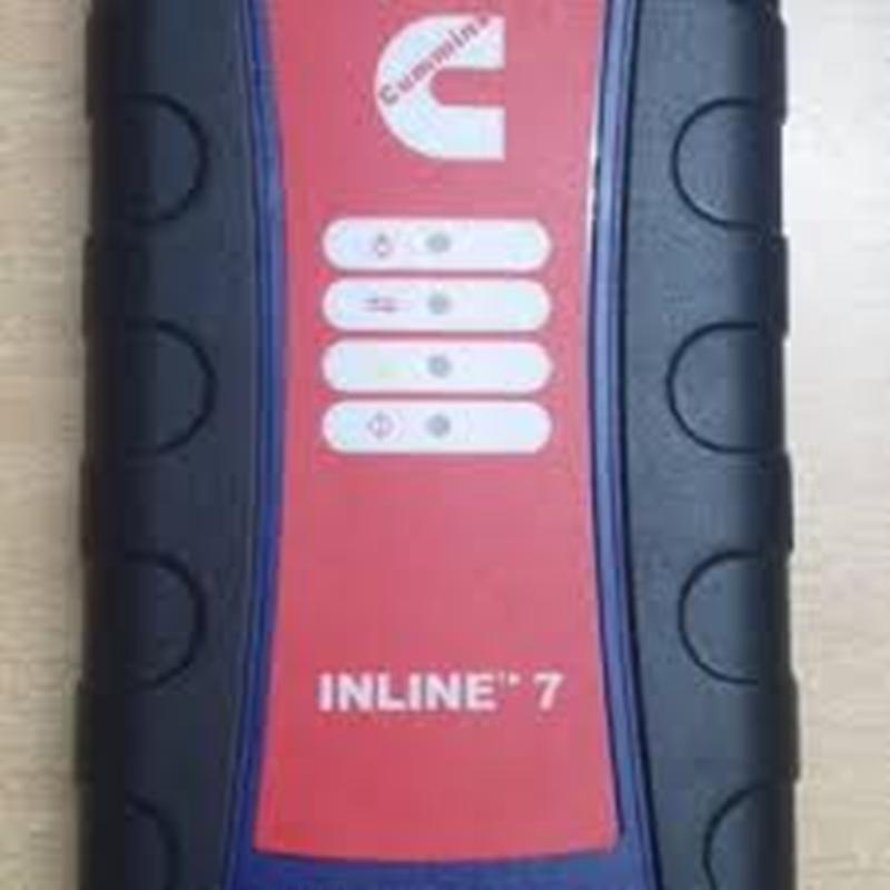 Red and black diagnostic scanner with 'Cummins' branding on a beige background